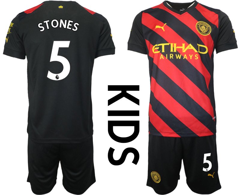 Kinder Fußballtrikots Manchester City 2022-23 Auswärtstrikot schwarz rot - Stones 5